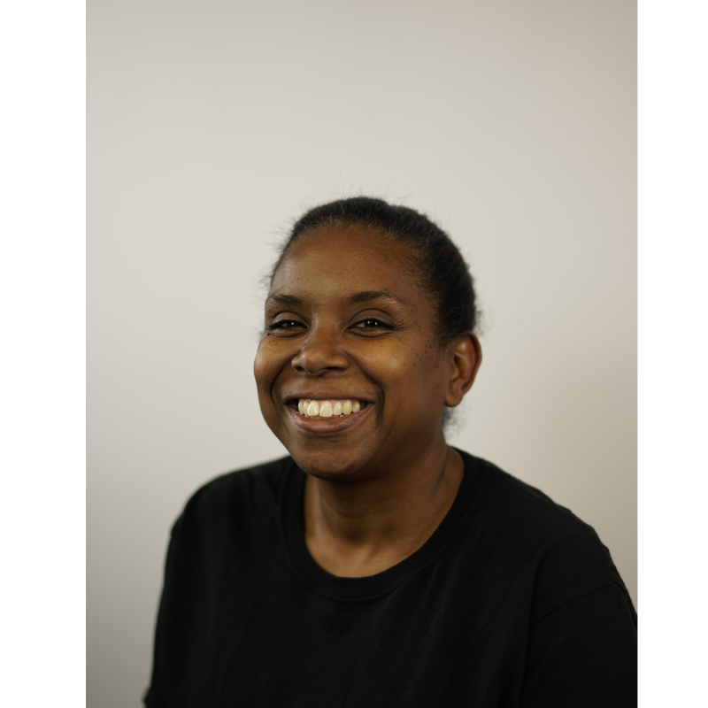 woman in black shirt smiling for company headshot