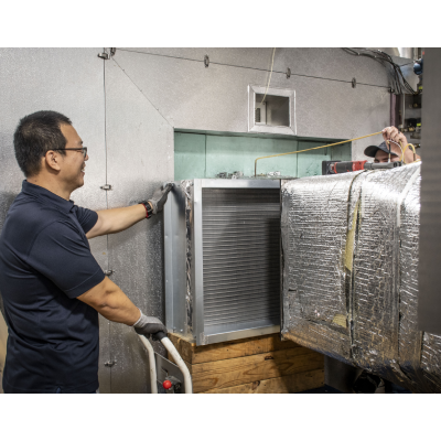 man installing heat exchanger into wind tunnel for testing